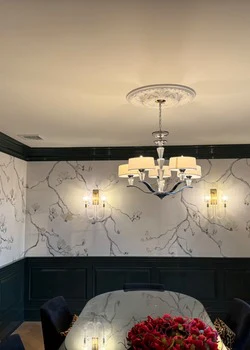 Dining room with mural walls, green wainscot and ceiling medallion