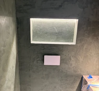 Venetian plaster feature wall with backlit stone panel