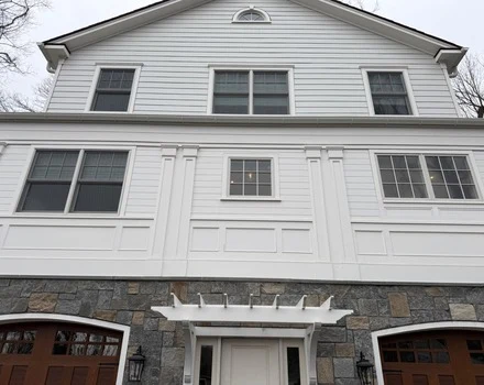 Shingle-style completed home exterior with painted trim