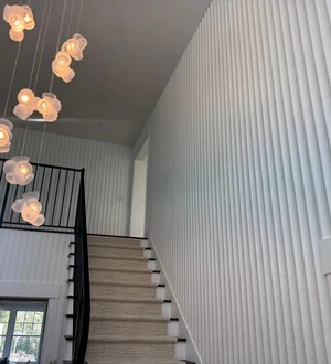 Fluted white wall paneling in a bright stairwell
