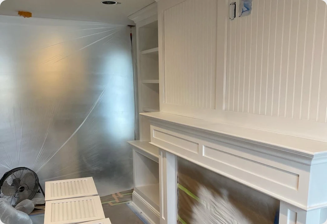 Custom white built-in shelving and beadboard finished on site