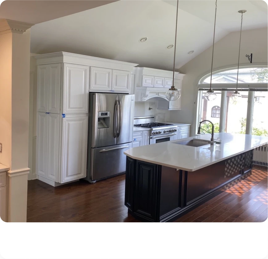 Custom white kitchen cabinetry and trim finished by United Painting of North Texas